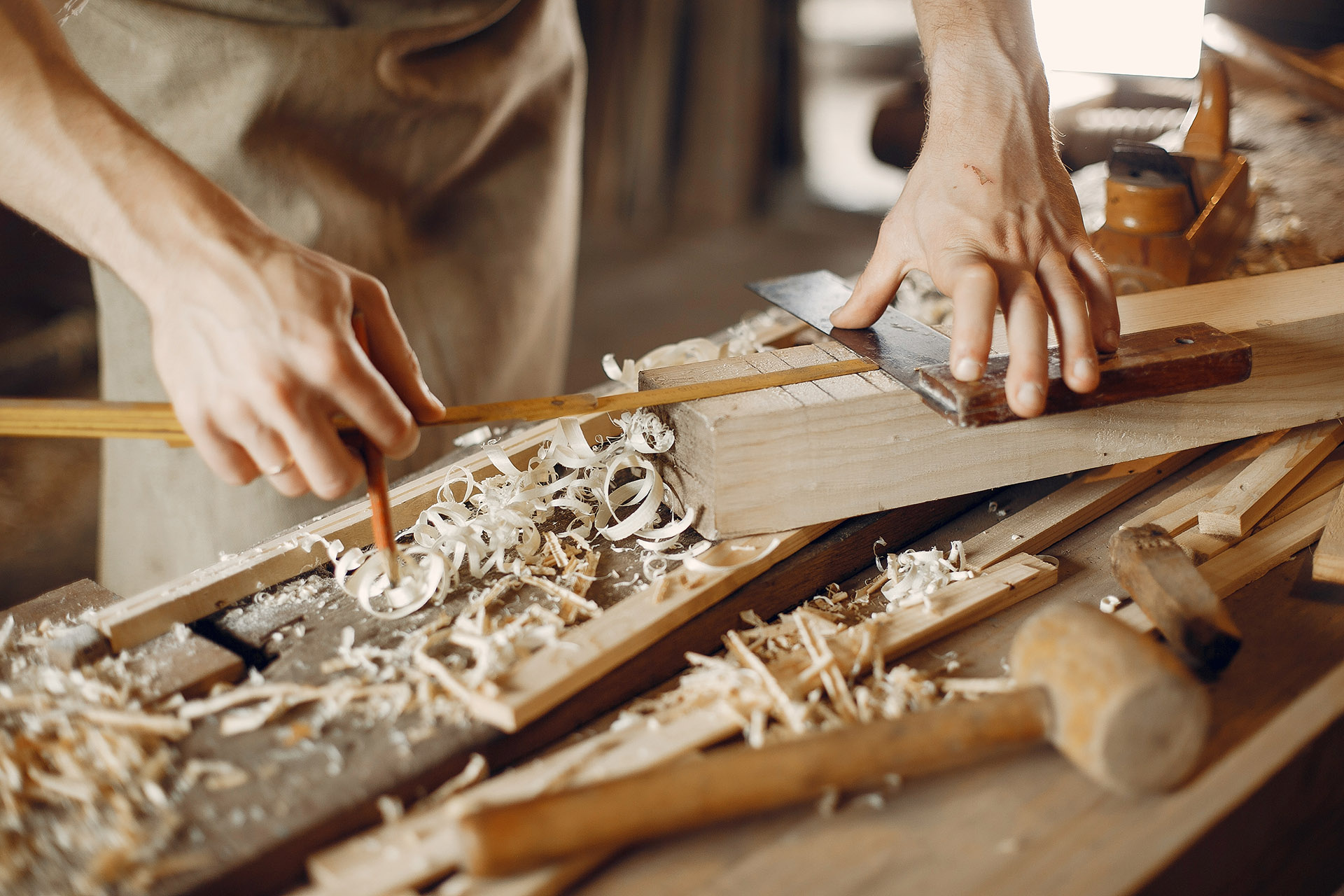 Handsome carpenter working with a wood